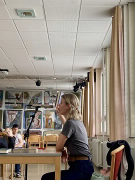 Sonja Kaiblinger sitzt am Mikrofon und spricht über ihr Buch.